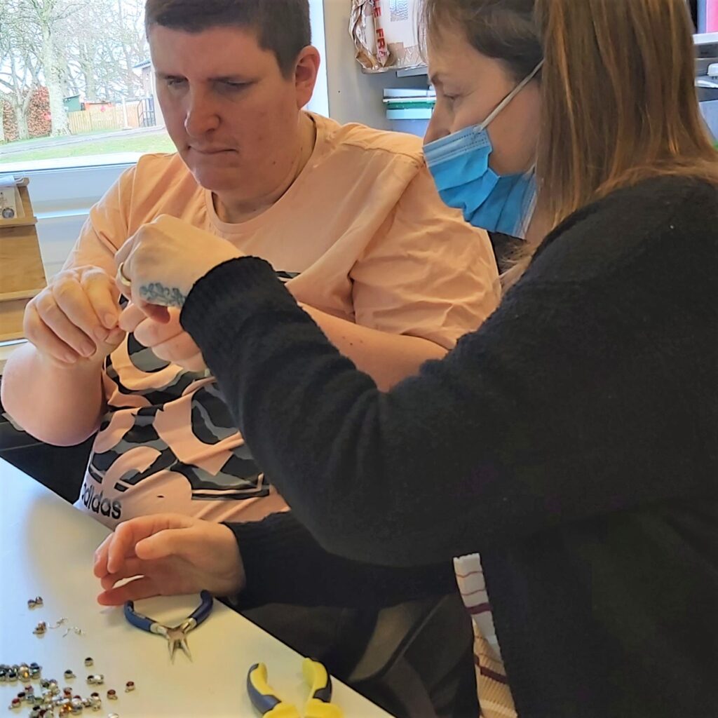 service user making jewellery Social Enterprise LOTUS