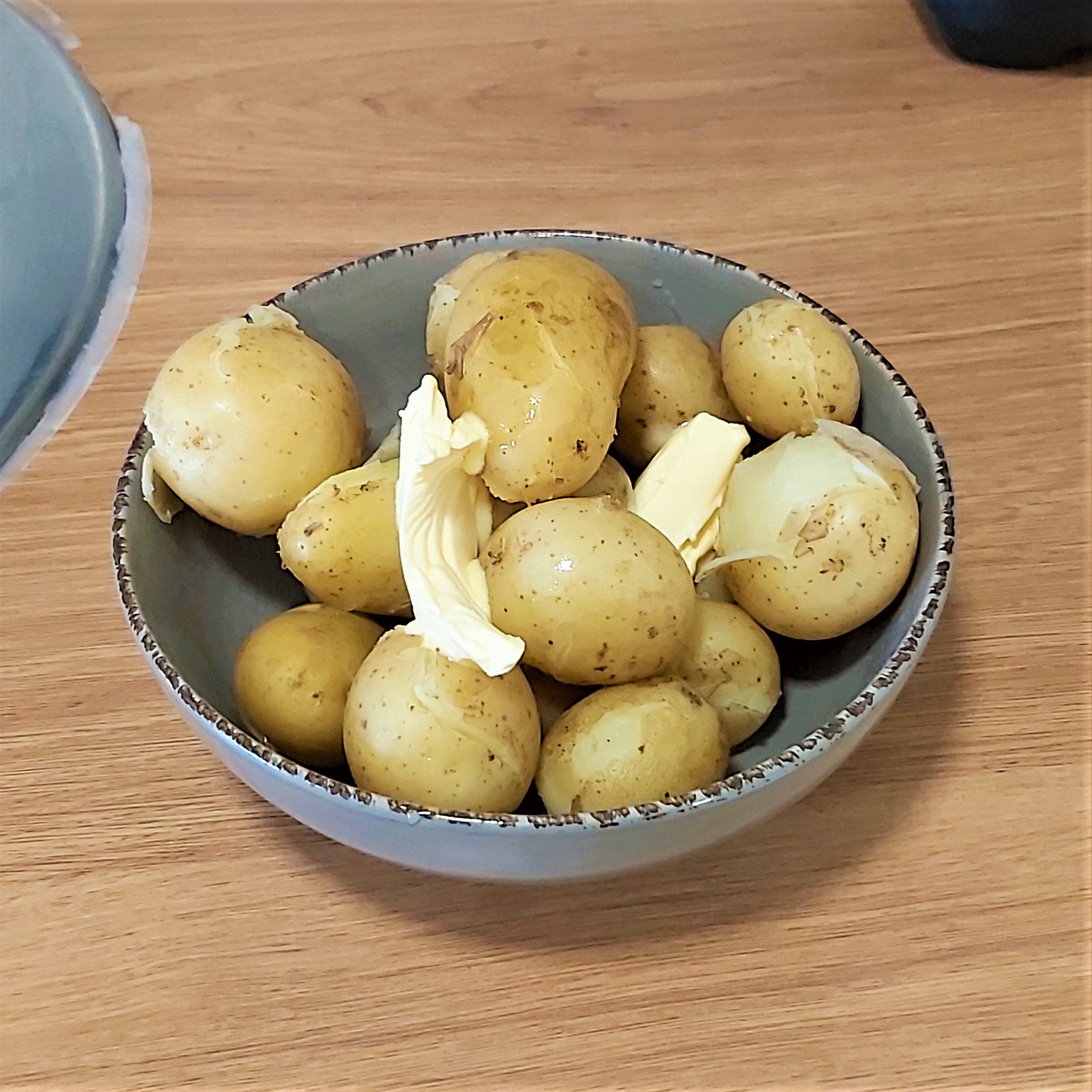 freshly picked new potatoes cooked in a dish with butter